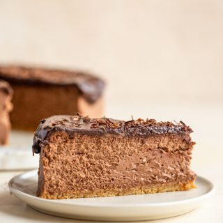 a slice of chocolate cheesecake on a white plate