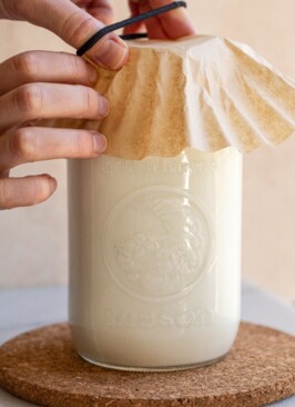 milk kefir in a glass jar putting a coffee filter on top