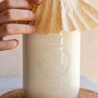 milk kefir in a glass jar putting a coffee filter on top