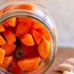 fermented carrots in a sideways glass jar