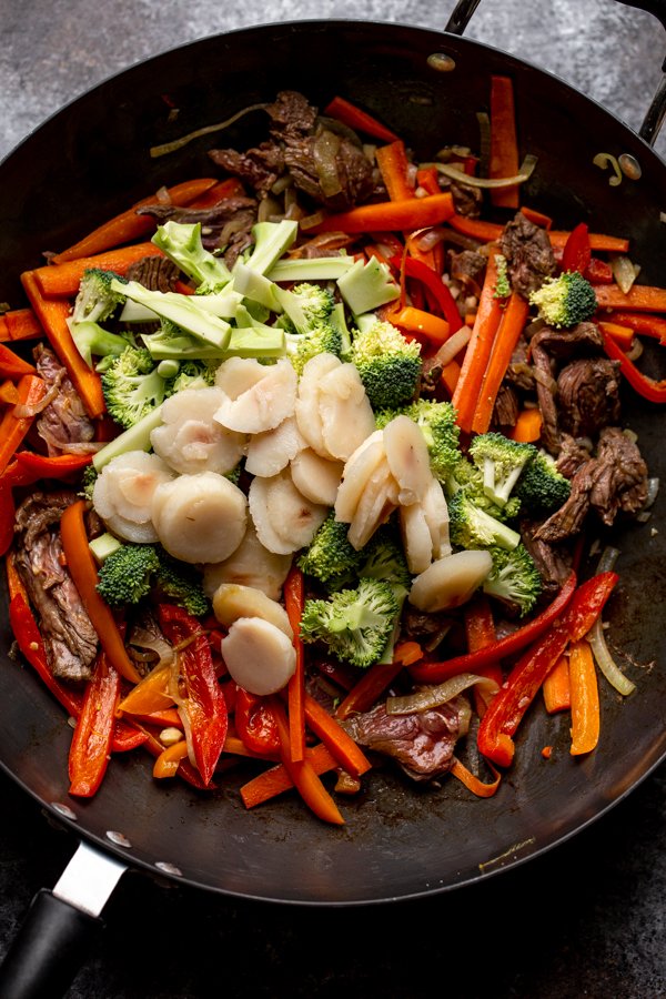 peppers, onions, carrots and venison steak in a wok with water chestnuts on top