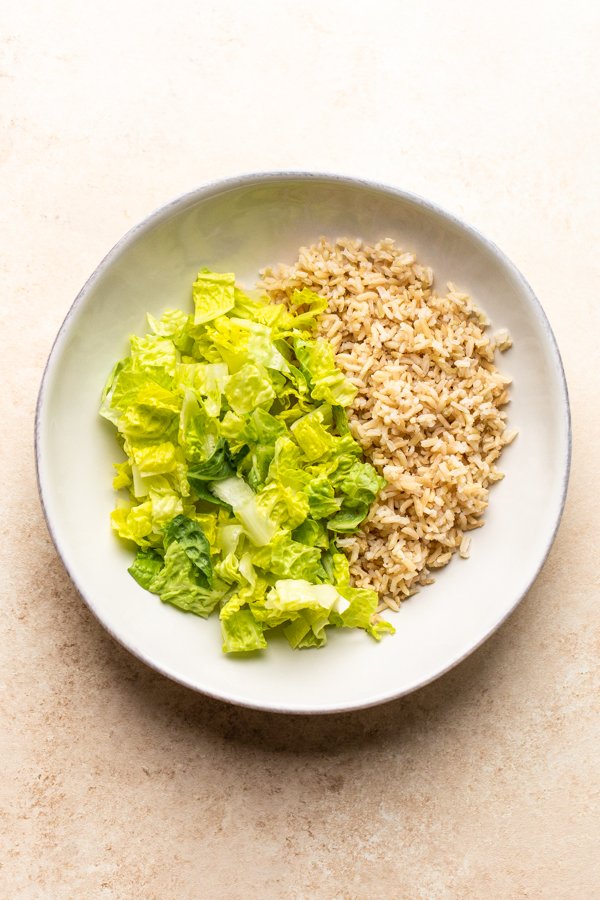 lettuce and rice in a white bowl