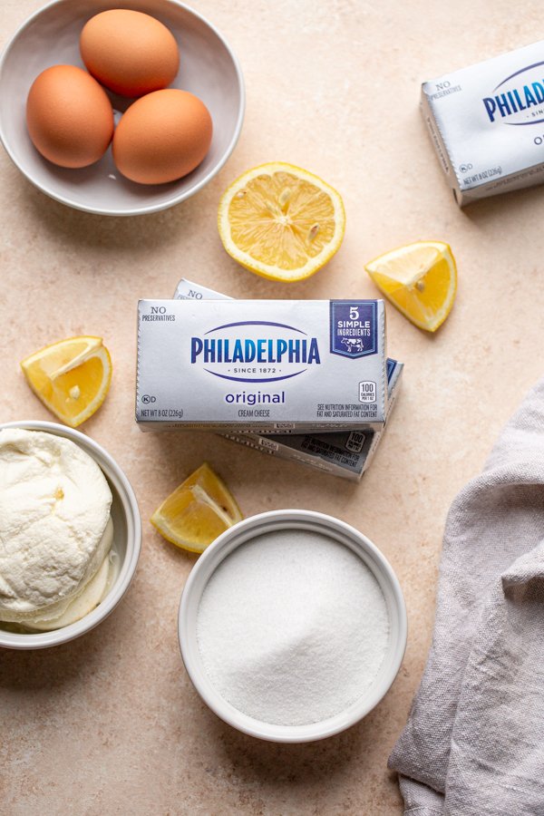 lemon cheesecake ingredients on a cream colored counter