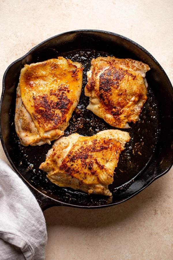 pan seared chicken thighs in a pan