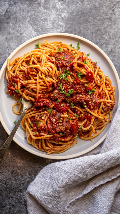 venison bolognese on a blue plate