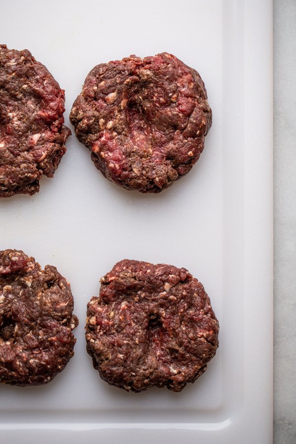 burger patties shaped on a cutting board