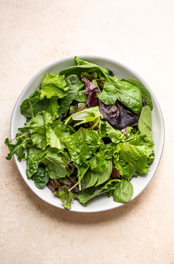 leafy lettuce in a white bowl