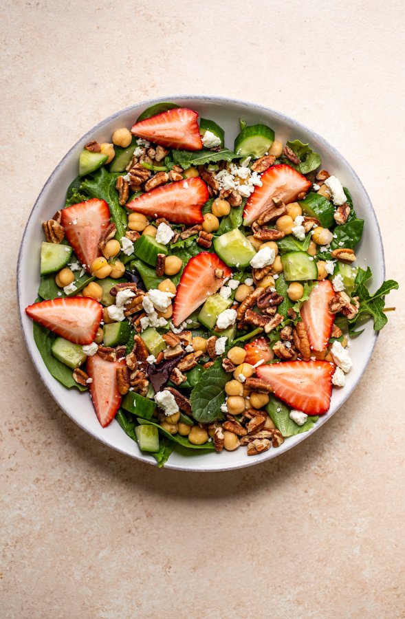 salad in a bowl with chickpeas, strawberry and feta