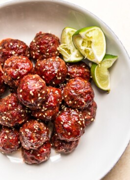 smoked venison meatballs in a white bowl with lime slices