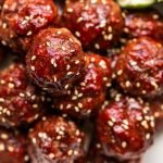 smoked venison meatballs in a white bowl with lime slices