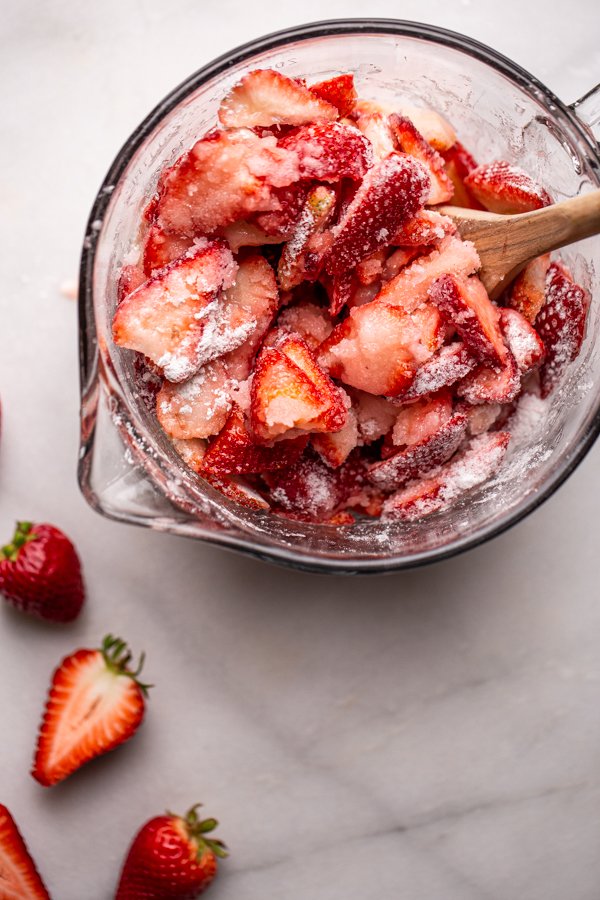 strawberries covered in sugar in a bowl