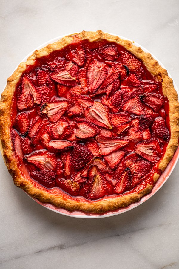 strawberry pie with fresh strawberries on a counter