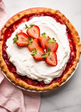 fresh strawberry pie with whipped cream on top