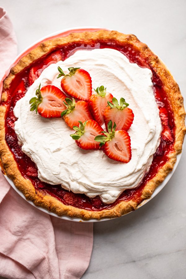 fresh strawberry pie with whipped cream on top