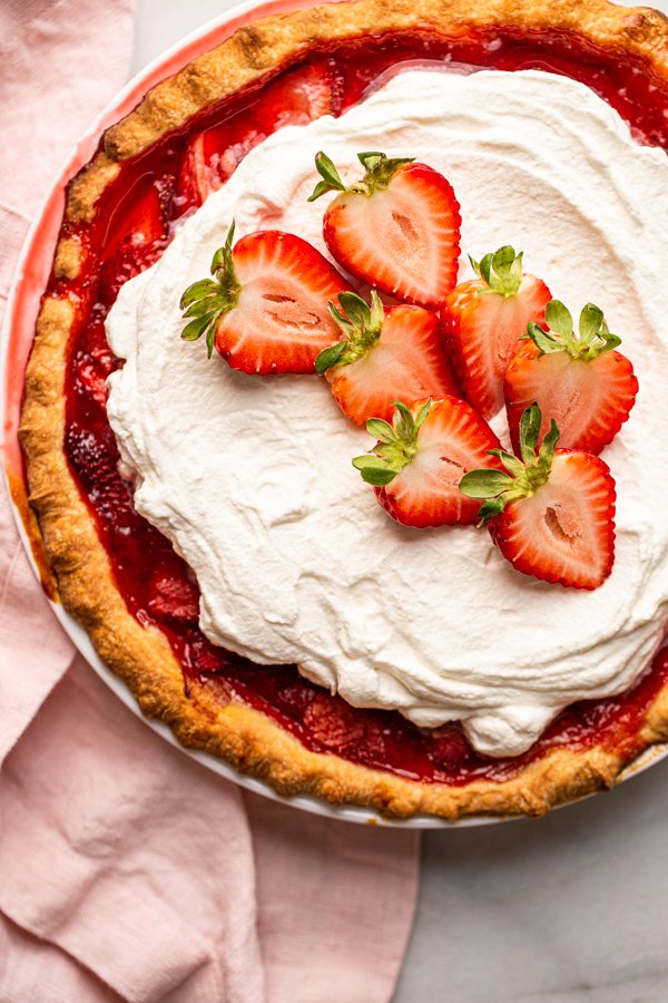 fresh strawberry pie with whipped cream on top