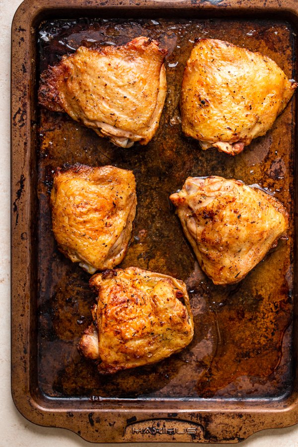 chicken thighs on a baking sheet