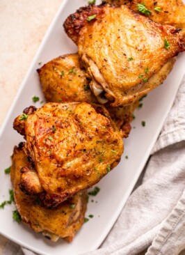 traeger grilled chicken thighs on a white rectangular plate