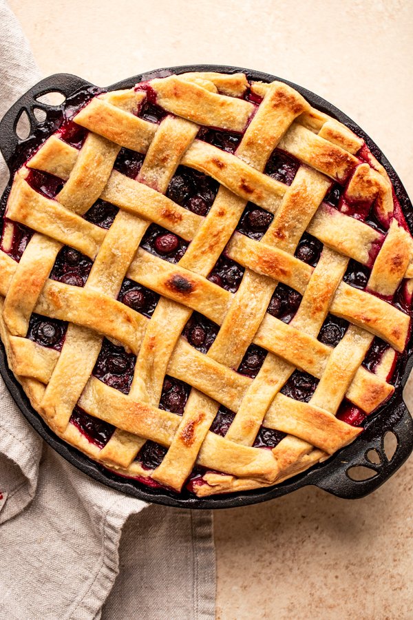 traeger pie with blueberries in a cast iron pie plate