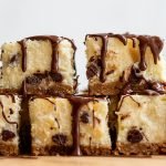 a stack of chocolate chip cheesecake bars