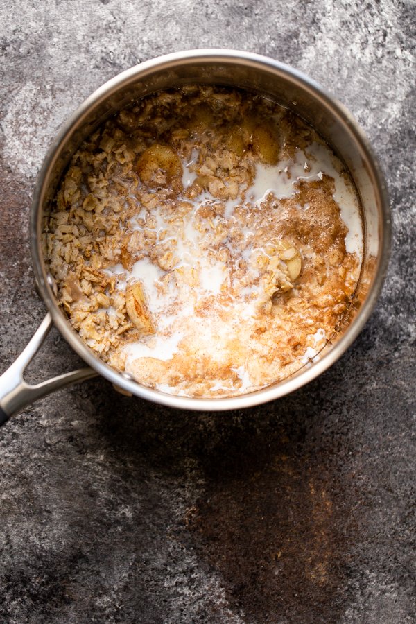 oatmeal with milk and bananas in a saucepan