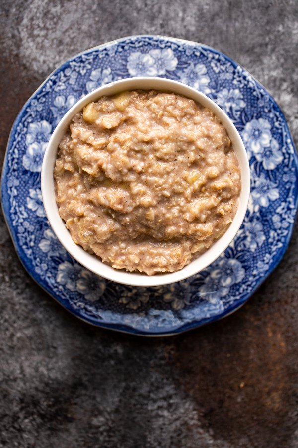 stovetop oatmeal in a white bowl on a blue and white plate