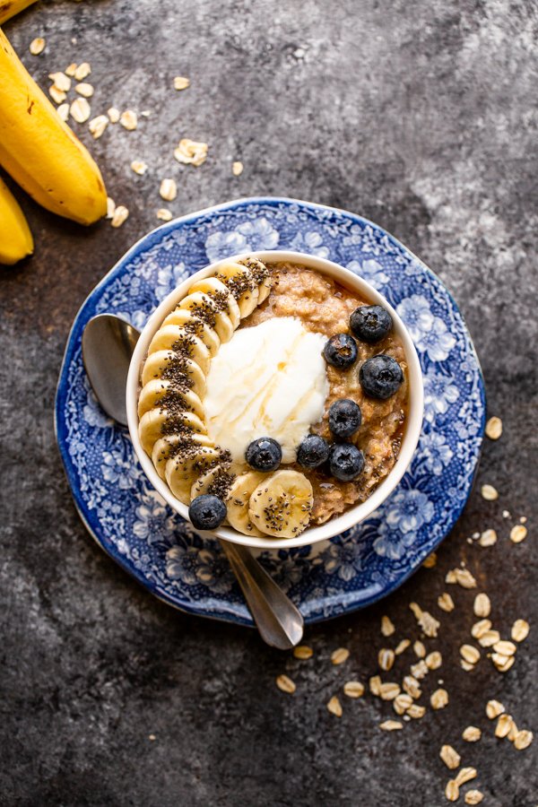 banana bread oatmeal in a white bowl on a blue and white plate