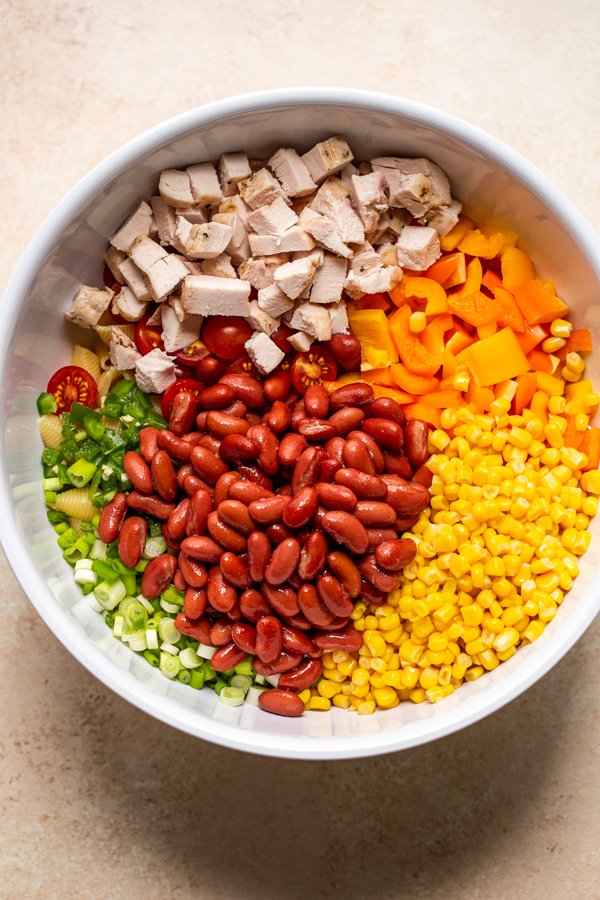 grilled chicken, beans, corn, and peppers in a white bowl