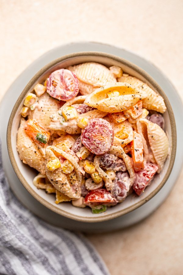 vegetarian southwest pasta salad in a white bowl on a cream counter