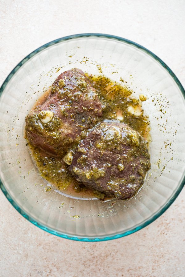 deer meat marinating in a glass bowl