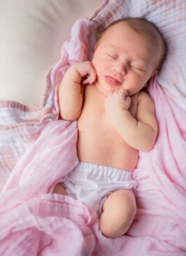 baby with pink blankets