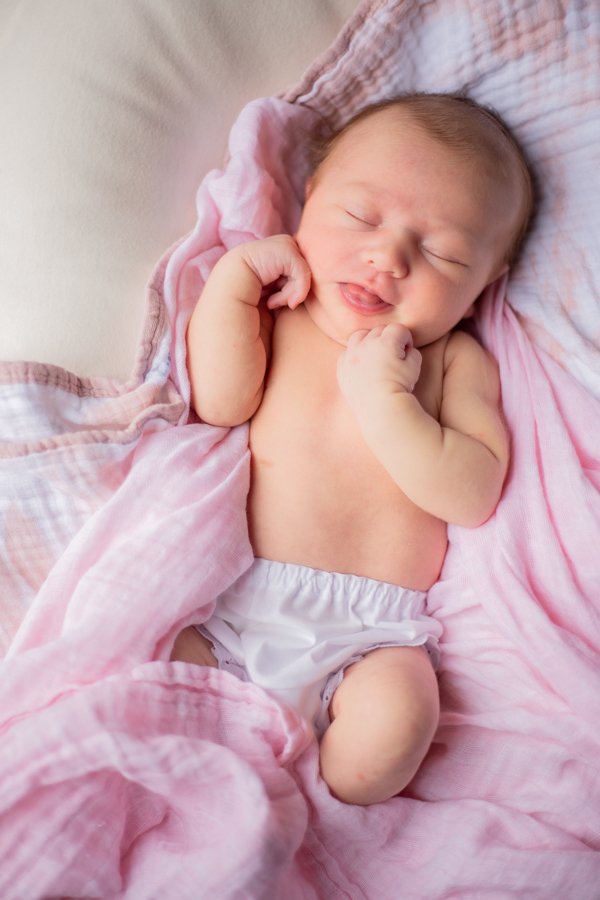 baby with pink blankets