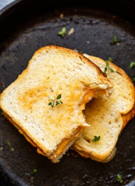 traeger grilled cheese stacked and cut in half on a skillet
