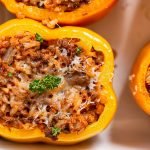 venison stuffed peppers in a white baking dish