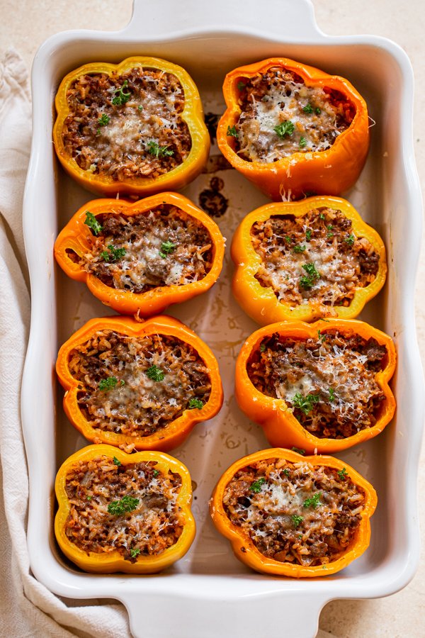 venison stuffed peppers in a white baking dish