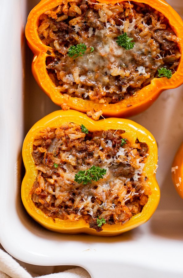 venison stuffed peppers in a white baking dish