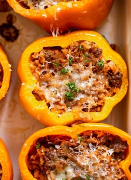 venison stuffed peppers in a white baking dish