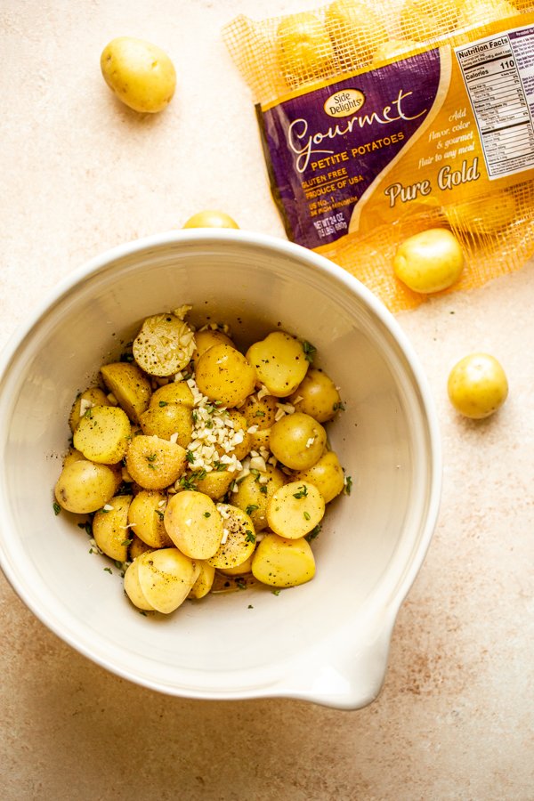 potatoes in a bowl with garlic and herbs