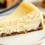 chocolate chip cookie crust cheesecake slice on a white plate