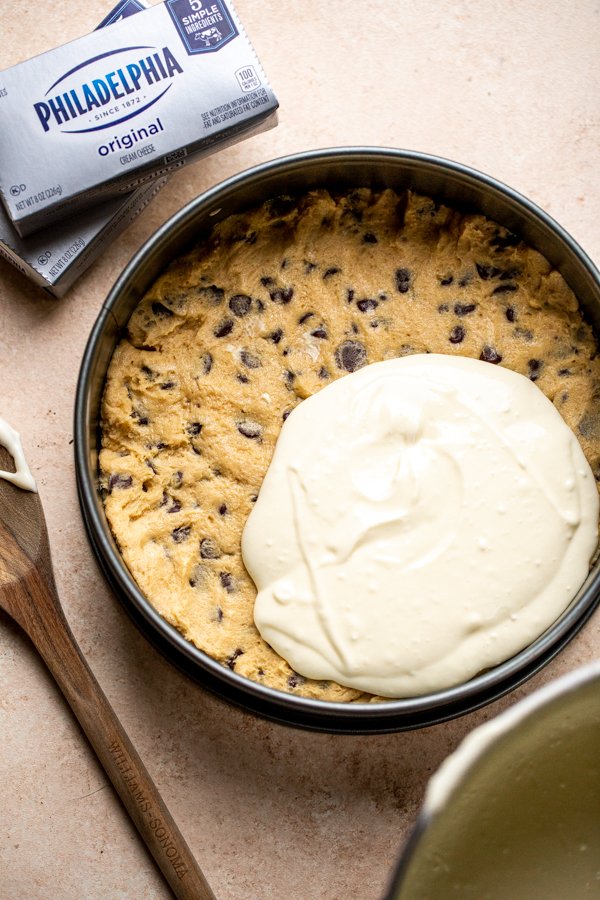 cheesecake batter over a cookie dough