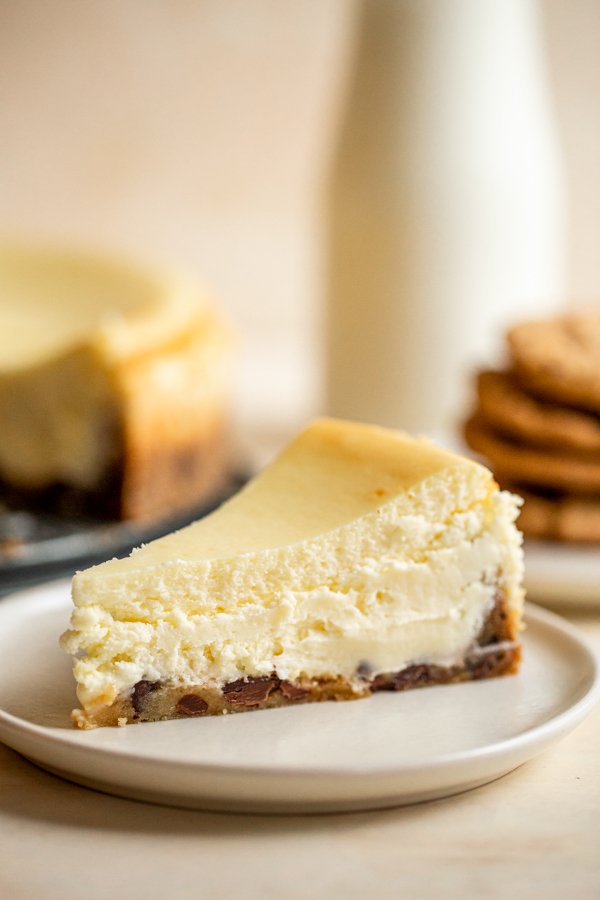 chocolate chip cookie crust cheesecake slice on a white plate