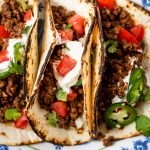 ground venison tacos on a blue and white plate