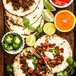 ground venison tacos on a sheet pan with all of the toppings out
