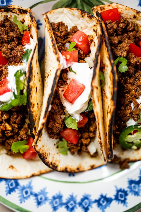 ground venison tacos on a blue and white plate