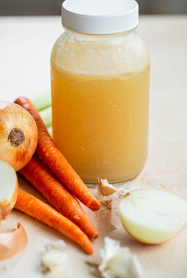 venison stock in a quart jar with onions, carrots and celery