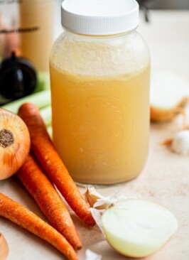 venison stock in a quart jar with onions, carrots and celery