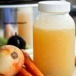 venison stock in a quart jar with onions, carrots and celery