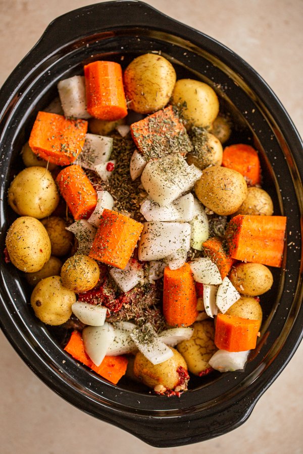 Small yellow potatoes, diced carrots, sliced onion, in crockpot with spices