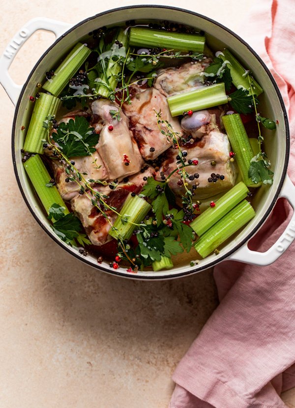 venison bones and aromatics in a pot with water for stock