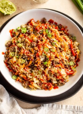 venison egg roll in a bowl in a white bowl on a black plate