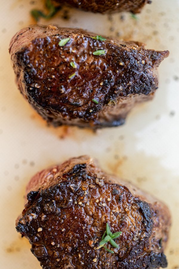 venison chops resting on a cutting board